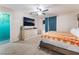 Comfortable main bedroom featuring a ceiling fan, modern dresser, and an orange and white comforter at 1328 Balzar Ave, Las Vegas, NV 89106