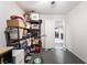 Organized storage room with shelving units, tile flooring, and view into an open-concept living space at 1328 Balzar Ave, Las Vegas, NV 89106