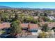 Expansive aerial view showcases the well-maintained neighborhood with mature trees and community featuring mountain views at 1561 Doran Dr, Las Vegas, NV 89123