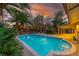 Lush backyard with a pool, mature trees, and manicured landscaping at 1561 Doran Dr, Las Vegas, NV 89123