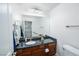 Bathroom showcasing a dark countertop and ample lighting with a large mirror at 1561 Doran Dr, Las Vegas, NV 89123