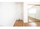Hallway with wood floors and a mirrored closet door reflecting a bright room at 1561 Doran Dr, Las Vegas, NV 89123