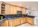 Updated kitchen with custom wood cabinetry, granite countertops, and stainless steel appliances at 1561 Doran Dr, Las Vegas, NV 89123