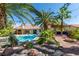 Inviting backyard pool with lush tropical landscaping and a cozy fire pit area at 1561 Doran Dr, Las Vegas, NV 89123