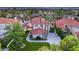 An elevated view showcases a beautiful home with lush landscaping, mature palm trees, and a circular driveway at 1905 Iron Ridge Dr, Las Vegas, NV 89117