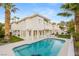 A beautiful backyard showcases a private swimming pool with a spacious patio and well-maintained lawn at 1905 Iron Ridge Dr, Las Vegas, NV 89117