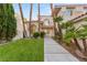 Charming two-story home with lush landscaping and mature palm trees at 1905 Iron Ridge Dr, Las Vegas, NV 89117