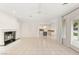 Bright open living room with a fireplace and access to the outdoor pool area at 1905 Iron Ridge Dr, Las Vegas, NV 89117