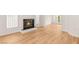 Open living space with beautiful hardwood floors, a cozy fireplace, and bright windows for an airy feel at 1905 Iron Ridge Dr, Las Vegas, NV 89117