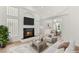 Bright living room boasts a fireplace, hardwood floors, and large windows for natural light at 1905 Iron Ridge Dr, Las Vegas, NV 89117