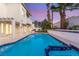 Enjoy the backyard pool with an outdoor kitchen and lounge area at 1905 Iron Ridge Dr, Las Vegas, NV 89117
