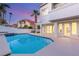 Sparkling pool with built in spa and covered outdoor kitchen area at 1905 Iron Ridge Dr, Las Vegas, NV 89117