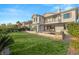 Expansive backyard featuring lush green grass, desert landscaping, and a beautiful pool with spa at 1987 Orchard Mist St, Las Vegas, NV 89135
