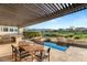 Outdoor living with a pool, spa, outdoor kitchen, and covered patio at 1987 Orchard Mist St, Las Vegas, NV 89135
