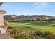 Beautiful backyard that overlooks a lush green golf course and features desert landscaping at 1987 Orchard Mist St, Las Vegas, NV 89135