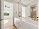 Bright bathroom featuring dual sinks, granite countertops and framed mirrors at 1987 Orchard Mist St, Las Vegas, NV 89135