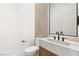 Powder room featuring modern fixtures, marble countertop, sink and patterned accent wall at 1987 Orchard Mist St, Las Vegas, NV 89135