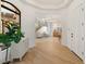 Welcoming foyer with an arched window, decorative cabinet, and staircase leading to the upper level at 1987 Orchard Mist St, Las Vegas, NV 89135