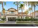 Stunning two-story home with lush landscaping and tall palm trees at 1987 Orchard Mist St, Las Vegas, NV 89135