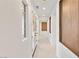 Hallway view featuring white walls, doors with glass inserts and beige carpeting at 1987 Orchard Mist St, Las Vegas, NV 89135