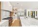Gourmet kitchen with a marble island, professional-grade appliances, and open layout to the dining area at 1987 Orchard Mist St, Las Vegas, NV 89135