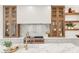 Gourmet kitchen with premium stainless steel appliances, marble countertops, and custom cabinetry at 1987 Orchard Mist St, Las Vegas, NV 89135