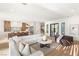 Open-concept living room connects to the kitchen, featuring a plush sofa and abundant natural light at 1987 Orchard Mist St, Las Vegas, NV 89135
