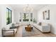 Bright living room features a cozy seating area, modern chandelier and outside view at 1987 Orchard Mist St, Las Vegas, NV 89135