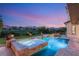 Swimming pool and spa with stone surround offer stunning views of distant mountains at 1987 Orchard Mist St, Las Vegas, NV 89135