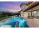 An inground swimming pool and spa enhance the backyard with an open transition to the indoors at 1987 Orchard Mist St, Las Vegas, NV 89135