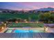 Backyard view of the pool and spa overlooking a golf course and mountain range at 1987 Orchard Mist St, Las Vegas, NV 89135