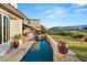 Beautiful pool runs the length of this backyard, which features desert landscaping and great views at 1987 Orchard Mist St, Las Vegas, NV 89135