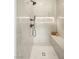 Luxurious shower with white tile surround, a shower bench, and a rainfall shower head at 1987 Orchard Mist St, Las Vegas, NV 89135