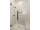 Modern shower with frameless glass door and white tile surround with built in bench at 1987 Orchard Mist St, Las Vegas, NV 89135