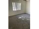 Bedroom with large window for natural light and gray carpeting throughout at 220 Mission Catalina Ln # 203, Las Vegas, NV 89107