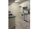 Bright kitchen features white cabinets, gray countertops and a white range at 220 Mission Catalina Ln # 203, Las Vegas, NV 89107