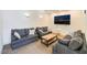 Relax in the communal living room with comfortable seating and a large screen television at 221 Mission Catalina Ln # 104, Las Vegas, NV 89107