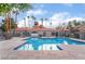 Enjoy this expansive community pool area surrounded by lush greenery and stylish poolside furnishings at 221 Mission Catalina Ln # 104, Las Vegas, NV 89107
