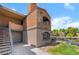 A street-level exterior showing stairs leading to a unit on the upper level with lovely landscaping around the building at 221 Mission Catalina Ln # 104, Las Vegas, NV 89107