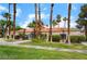 Landscaped one-story community building features a red tile roof and multiple palm trees at 221 Mission Catalina Ln # 104, Las Vegas, NV 89107