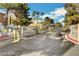 Community entrance features a security gate and lush landscaping at 221 Mission Catalina Ln # 104, Las Vegas, NV 89107