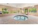 A peaceful indoor hot tub area is surrounded by natural light streaming through large windows at 221 Mission Catalina Ln # 104, Las Vegas, NV 89107