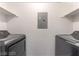 Functional laundry area featuring modern appliances and practical shelving for storage and organization at 221 Mission Catalina Ln # 104, Las Vegas, NV 89107