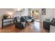 Bright living room featuring modern furnishings and a sliding glass door to the balcony at 221 Mission Catalina Ln # 104, Las Vegas, NV 89107