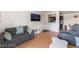 Bright living room with hardwood floors, neutral-toned furniture, and a view into the kitchen area at 221 Mission Catalina Ln # 104, Las Vegas, NV 89107