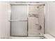 Close-up of the shower tub, tiled and featuring a sliding glass door enclosure at 221 Mission Catalina Ln # 104, Las Vegas, NV 89107
