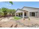 Landscaped backyard featuring decorative rocks, artificial turf, covered patio, and privacy at 2555 Moonlight Valley Ave, Henderson, NV 89044