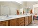 This bathroom features a double sink vanity, a shower with sliding doors and a view into the bedroom at 2555 Moonlight Valley Ave, Henderson, NV 89044