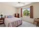Relaxing bedroom featuring a light color palette, ceiling fan, and views from the window at 2555 Moonlight Valley Ave, Henderson, NV 89044