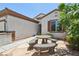 Inviting courtyard featuring a unique stone table with benches, accessible from the front entrance of the house at 2555 Moonlight Valley Ave, Henderson, NV 89044